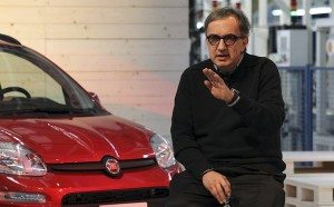 FILE - In this December 14, 2011 file photo, Fiat and Chrysler CEO Sergio Marchionne gestures next to the Fiat Panda model, at the Pomigliano D'Arco Fiat plant, near Naples, Italy. The Italian carmaker Fiat SpA says it will suspend production at its Naples plant for 12 days next month as car sales in Italy drop to the lowest levels in 30 years. Fiat said Wednesday, July 18, 2012 that it will close the Pomigliano plant, which makes the subcompact Panda model, from Aug. 20-31 to avoid "the useless and costly accumulation of vehicles." The extraordinary shutdown is in addition to a month-long holiday closure that begins July 23. (AP Photo/Lapresse, file) ITALY OUT