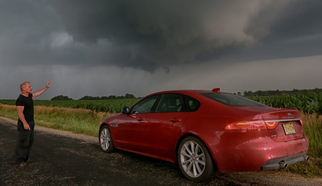 Tornado Tim drives a country road in search of an oncoming Tornado outside of Princeton Illinois on Wednesday June 22, 2016 (photo by Sandy Huffaker/Jaguar)